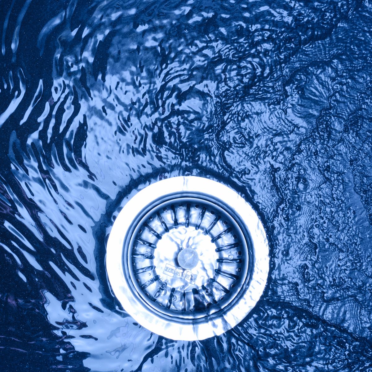 Emergency drain unblocking Water draining through a plughole