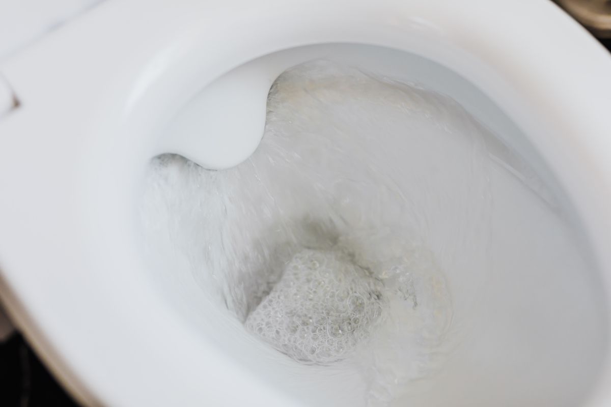 Overflowing toilet repairs Water swirling in a toilet bowl